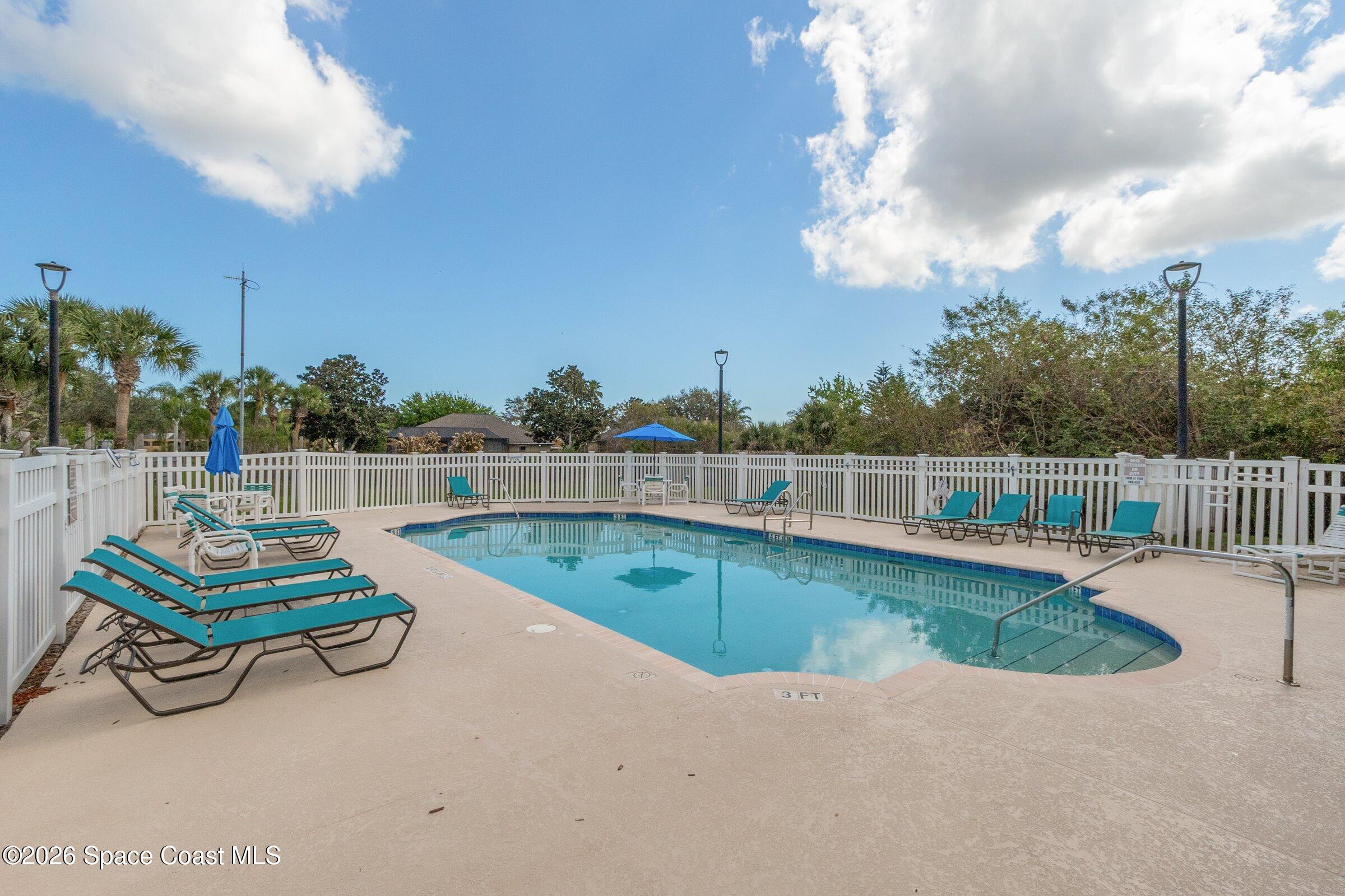1825 Ficus Point Drive Melbourne, FL 32940 - Photo 36 of 48 a view of a swimming pool with a garden