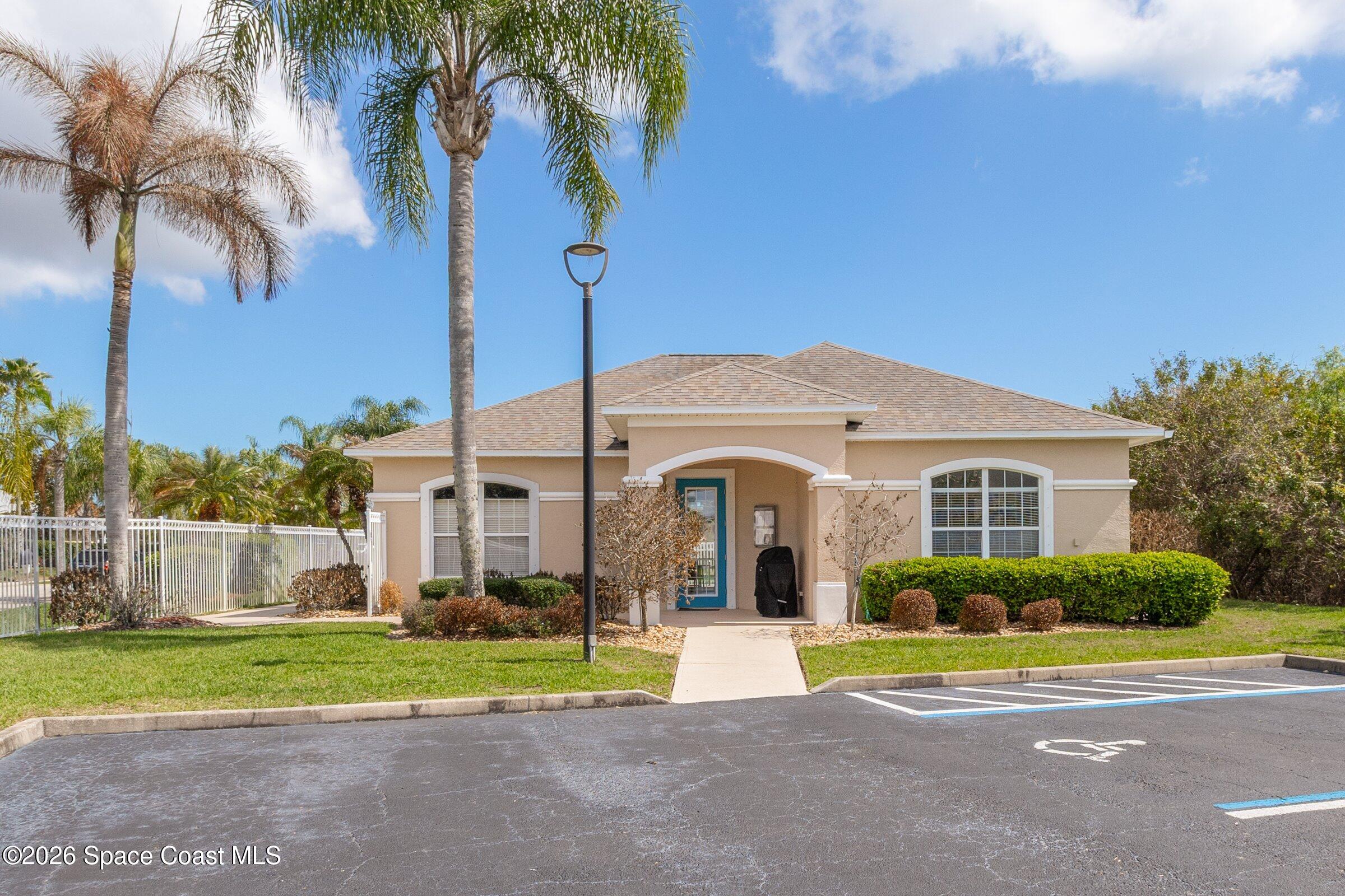 1825 Ficus Point Drive Melbourne, FL 32940 - Photo 38 of 48 a front view of a house with a yard and palm trees