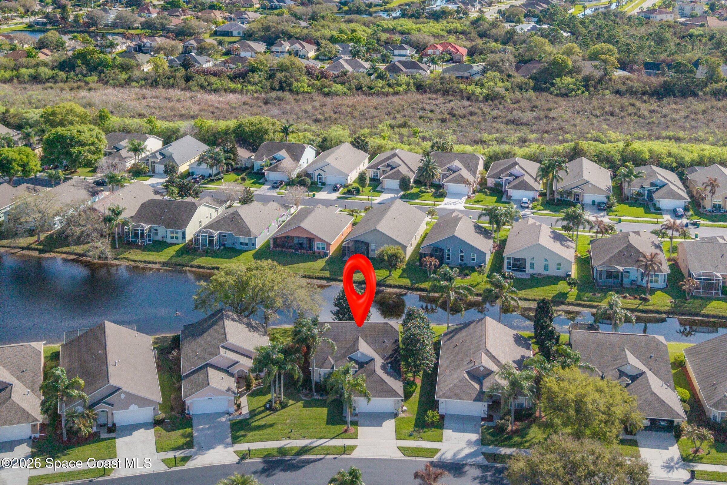 1825 Ficus Point Drive Melbourne, FL 32940 - Photo 5 of 48 an aerial view of lake and residential houses with outdoor space