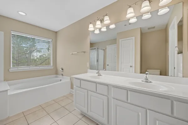 a white bath tub sitting next to a shower