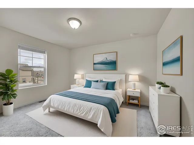 a bedroom with a bed and a potted plant