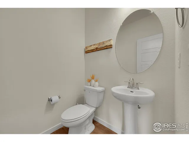 a bathroom with a sink mirror and toilet