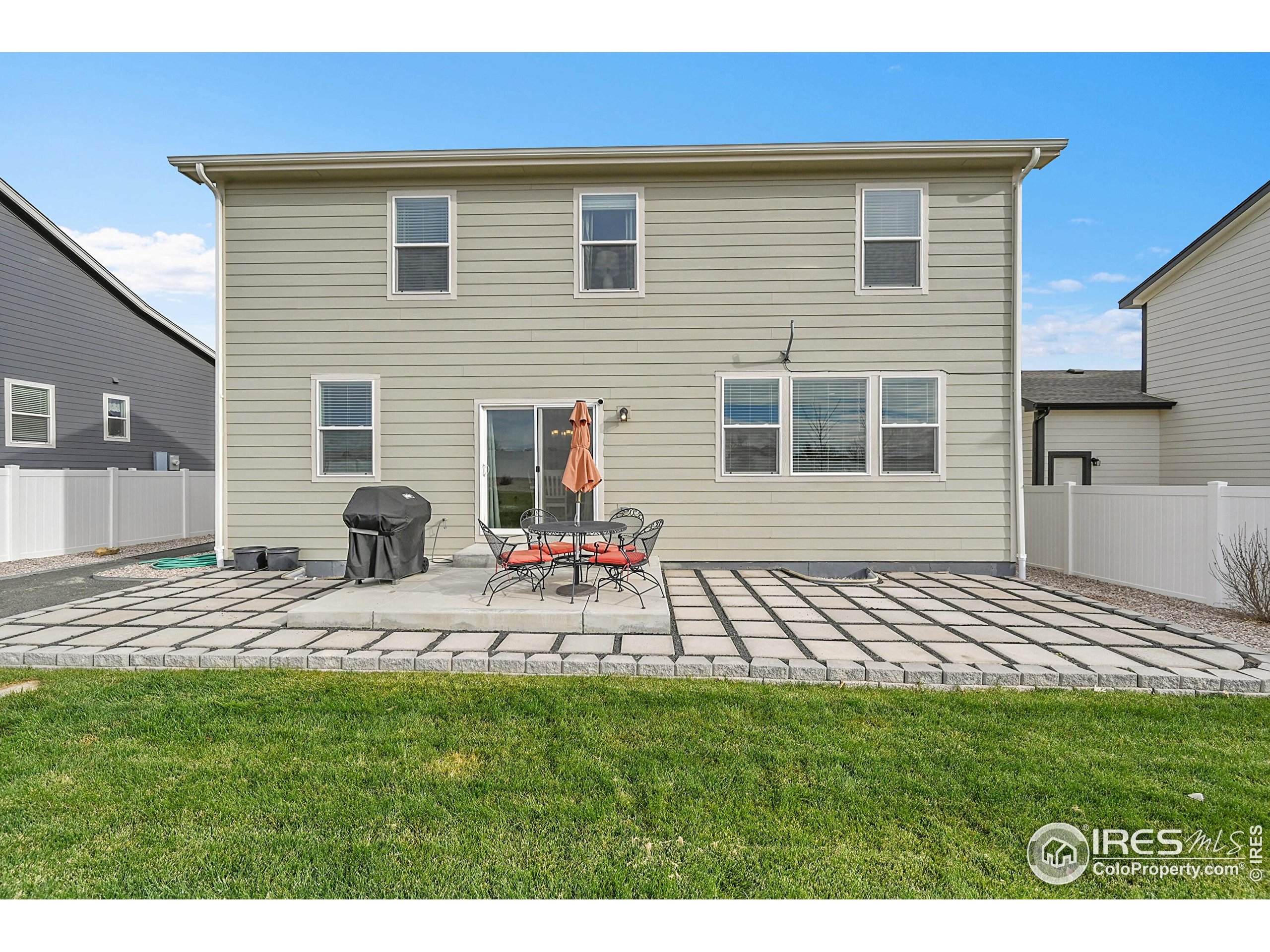 2538 Doe Rdg Way Johnstown, CO 80534 - Photo 24 of 33 a view of a backyard with table and chairs and wooden fence