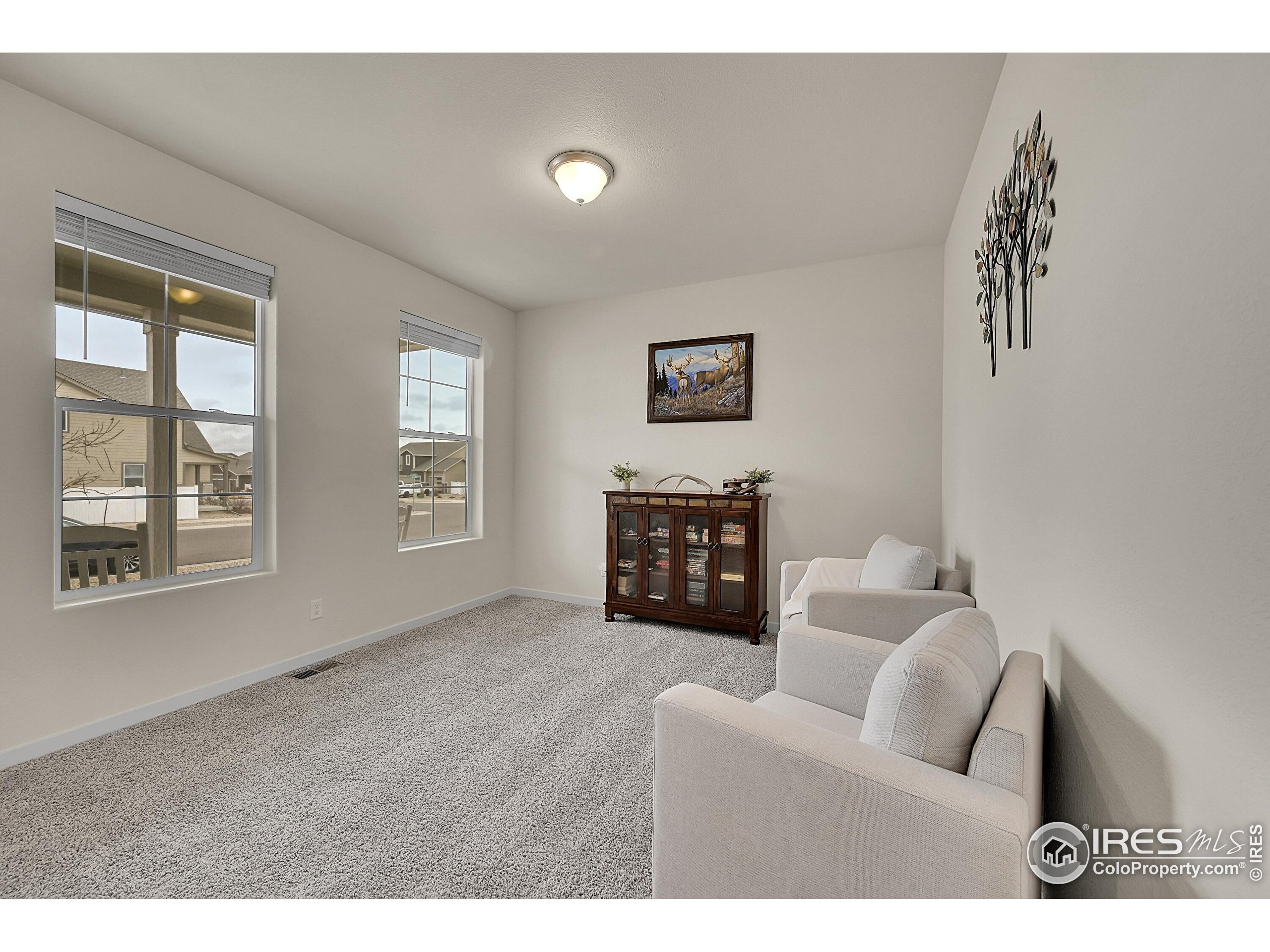 2538 Doe Rdg Way Johnstown, CO 80534 - Photo 4 of 33 a living room with furniture and a floor to ceiling window