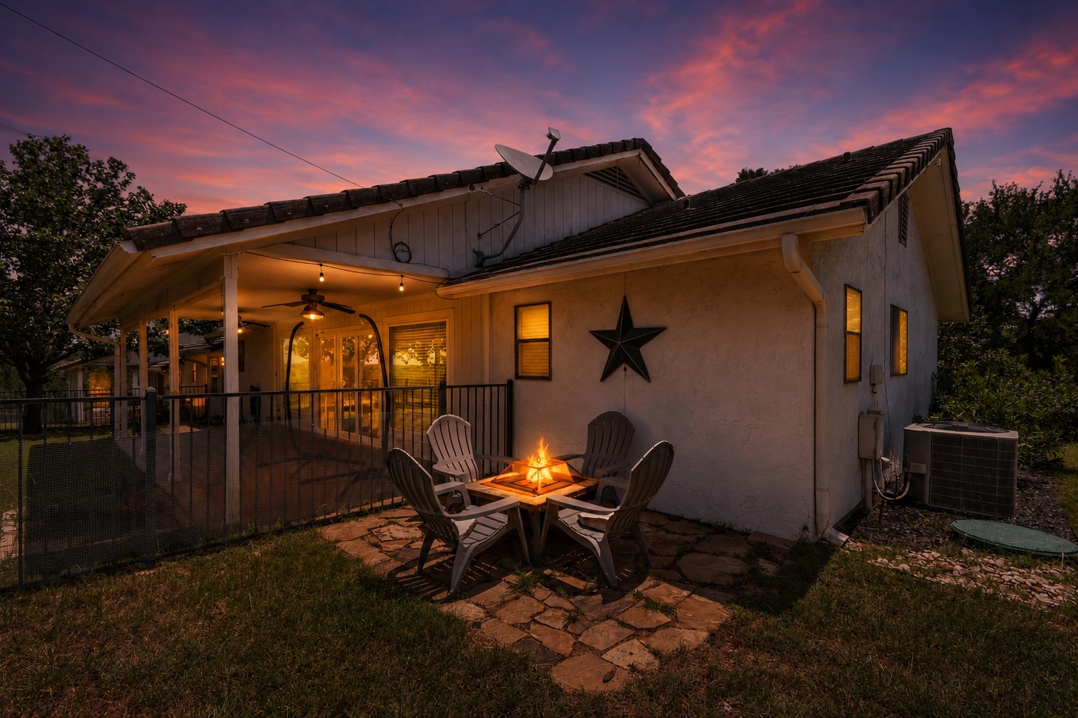 210 Teeoff, Unit B Horseshoe Bay, TX 78657 - Photo 35 of 38 A flagstone patio and fire pit create an inviting outdoor gathering spot at twilight.