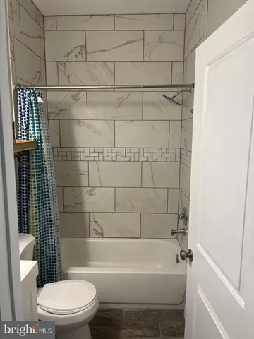 a bathroom with a toilet and shower