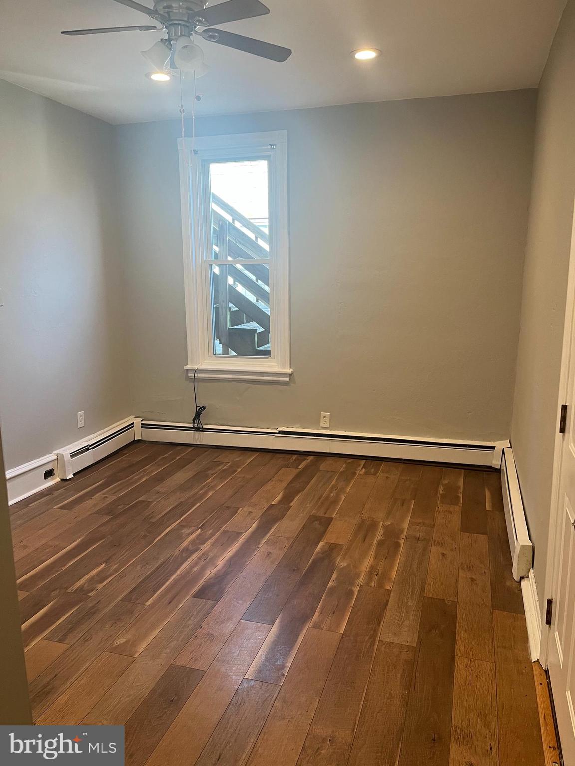 55 North Main Street Chalfont, PA 18914 - Photo 4 of 15 an empty room with wooden floor and windows
