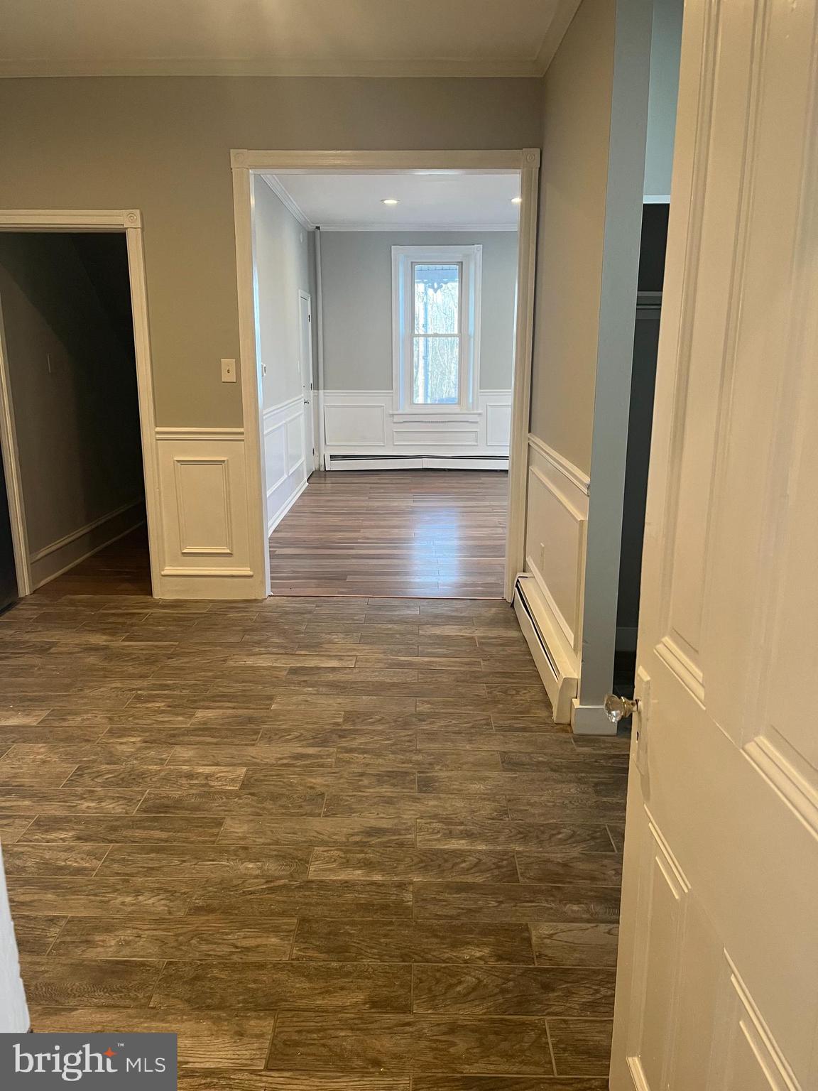 55 North Main Street Chalfont, PA 18914 - Photo 6 of 15 a view of a hallway with wooden floor and staircase
