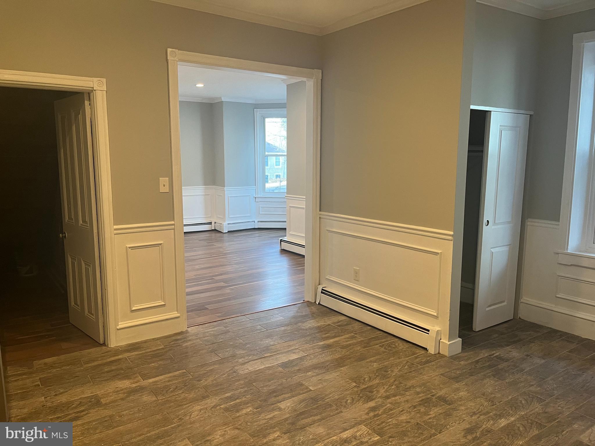 55 North Main Street Chalfont, PA 18914 - Photo 7 of 15 an empty room with wooden floor and windows