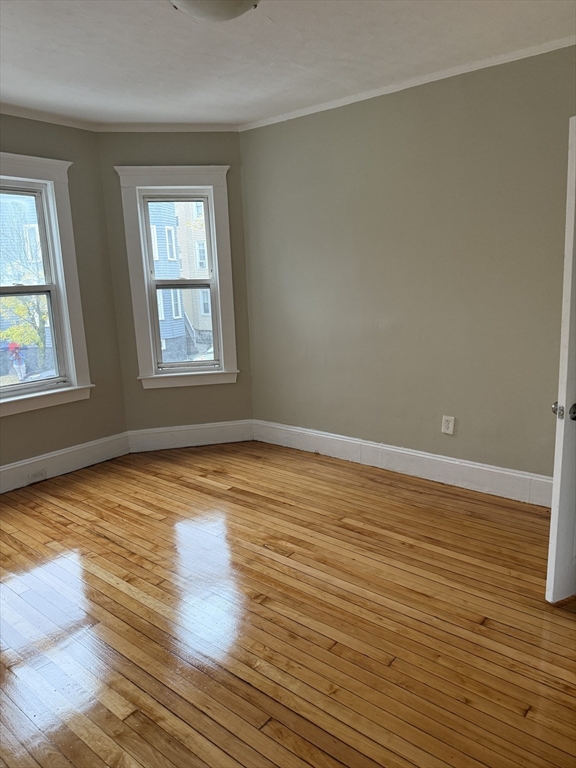 395 Talbot Avenue, Unit 1 Boston, MA 02124 - Photo 4 of 7 wooden floor in an empty room with a window