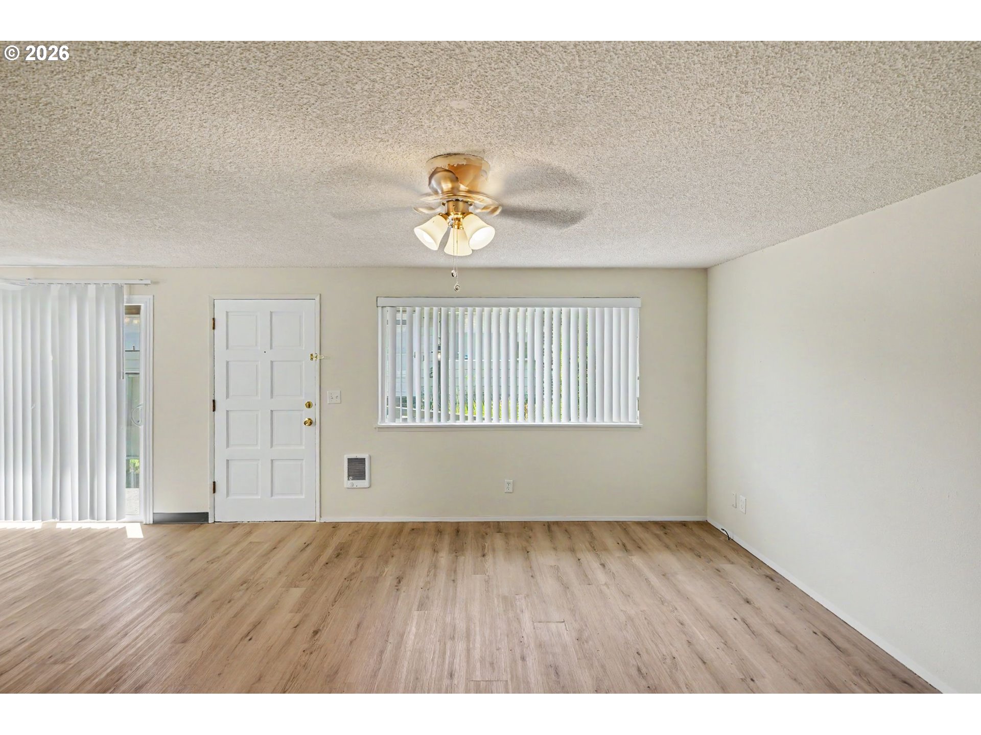 777 Boone Road Southeast, Unit 12 Salem, OR 97302 - Photo 3 of 16 a view of an empty room with wooden floor and a window