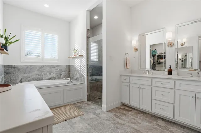a bathroom with a sink a mirror and a shower