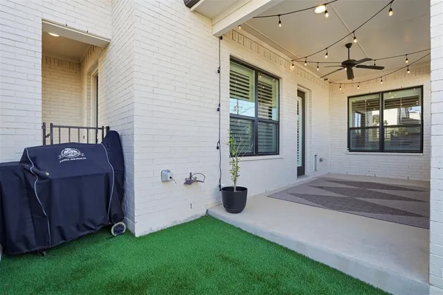 a view of garage and car parked in front of house
