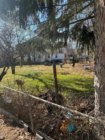 a view of a yard with large trees
