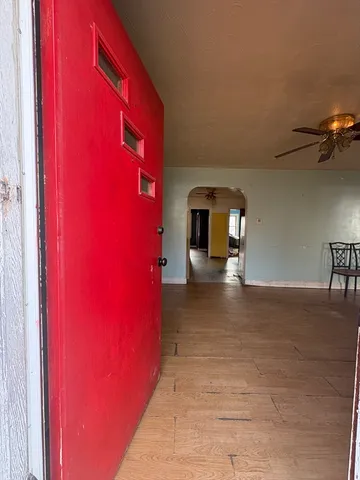 a view of empty room with a red door