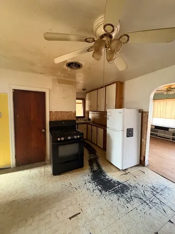 a kitchen with a refrigerator and window