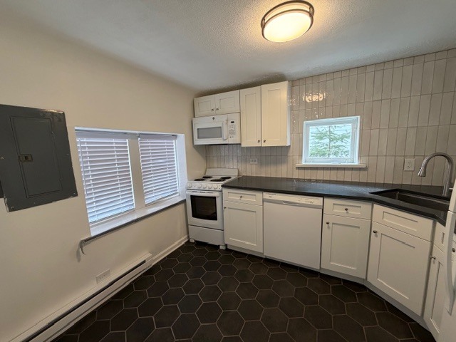 5938 Dunham Road Downers Grove, IL 60516 - Photo 7 of 16 a kitchen with granite countertop white cabinets and white appliances