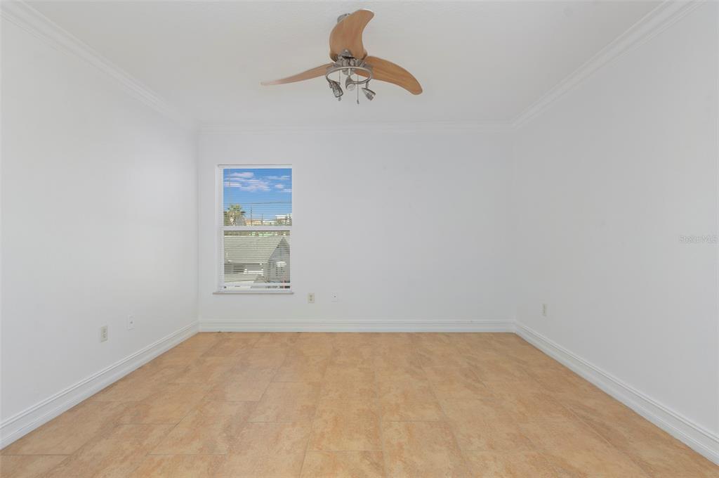 114 143rd Avenue, Unit A Madeira Beach, FL 33708 - Photo 13 of 15 a bathroom with a window and a ceiling fan