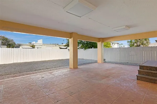 a view of backyard with wooden fence