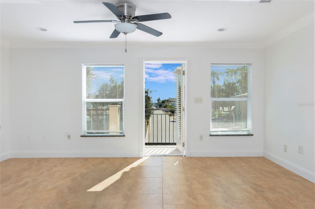 114 143rd Avenue, Unit A Madeira Beach, FL 33708 - Photo 7 of 15 an empty room with windows and fan