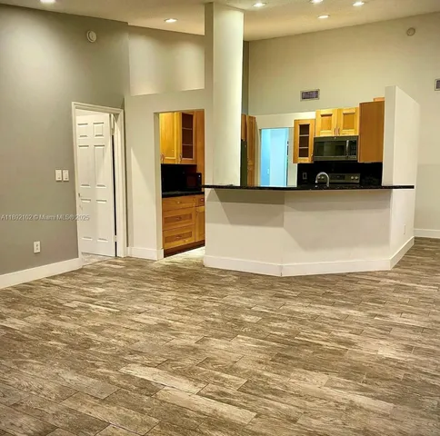 a view of a kitchen and a window
