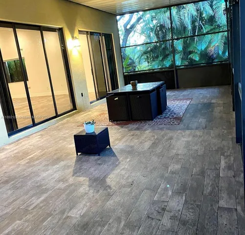a living room with couches bookshelf and a large window