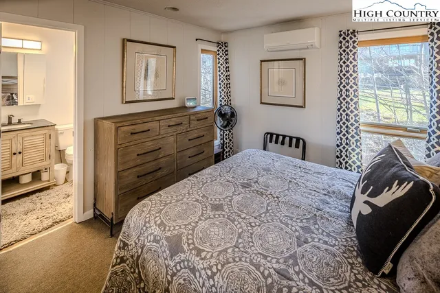 a bathroom with a granite countertop sink toilet and a mirror