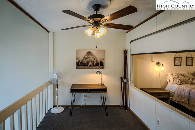 a view of a livingroom with furniture and a hallway