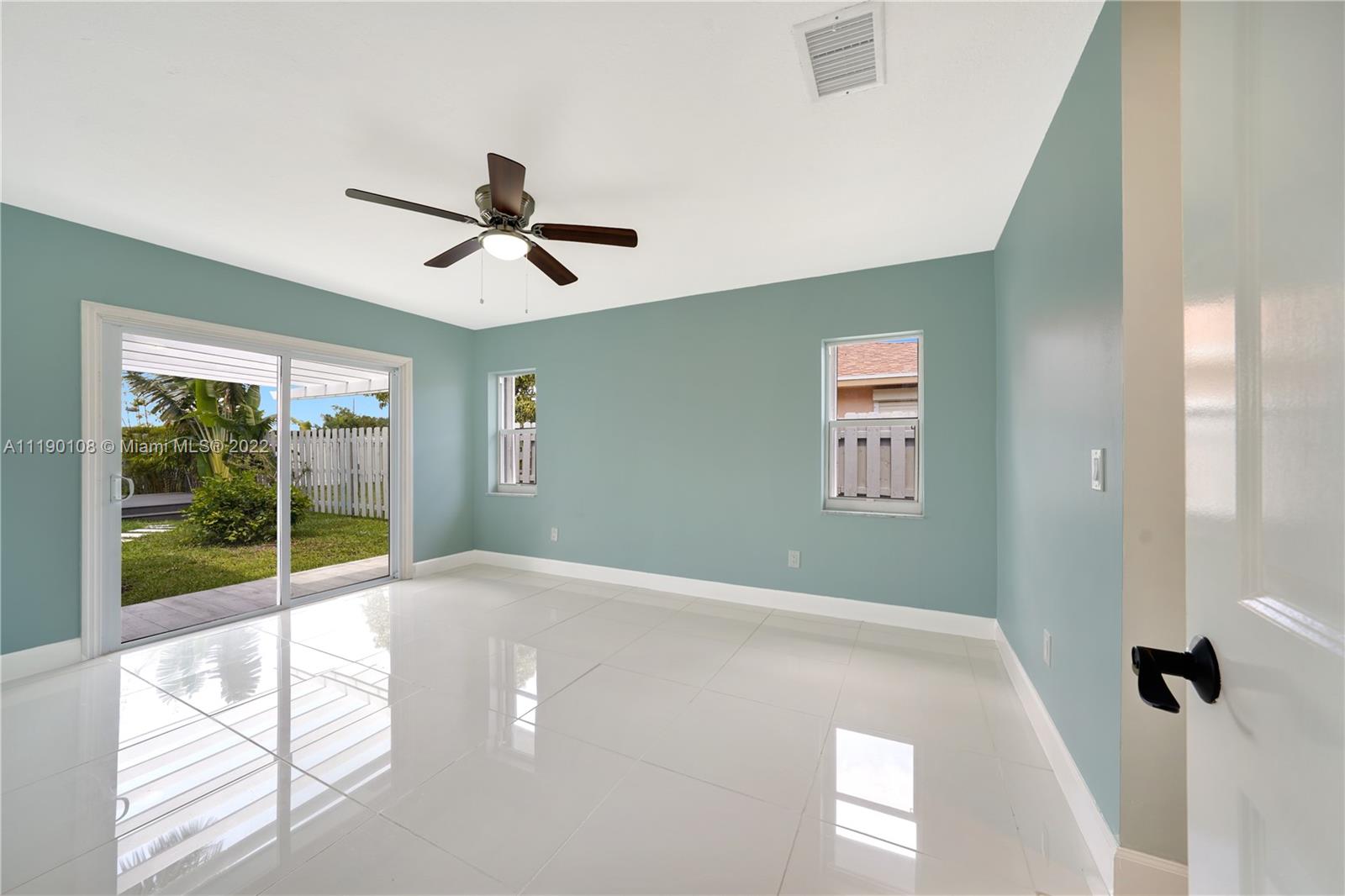 4641 Armadillo Street Boca Raton, FL 33428 - Photo 22 of 60 a view of a livingroom with a ceiling fan and window