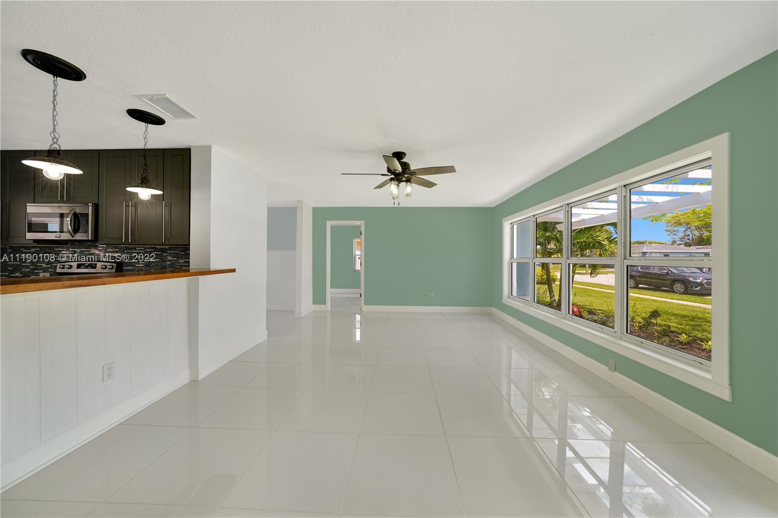4641 Armadillo Street Boca Raton, FL 33428 - Photo 3 of 60 a view of an empty room with a window and kitchen view