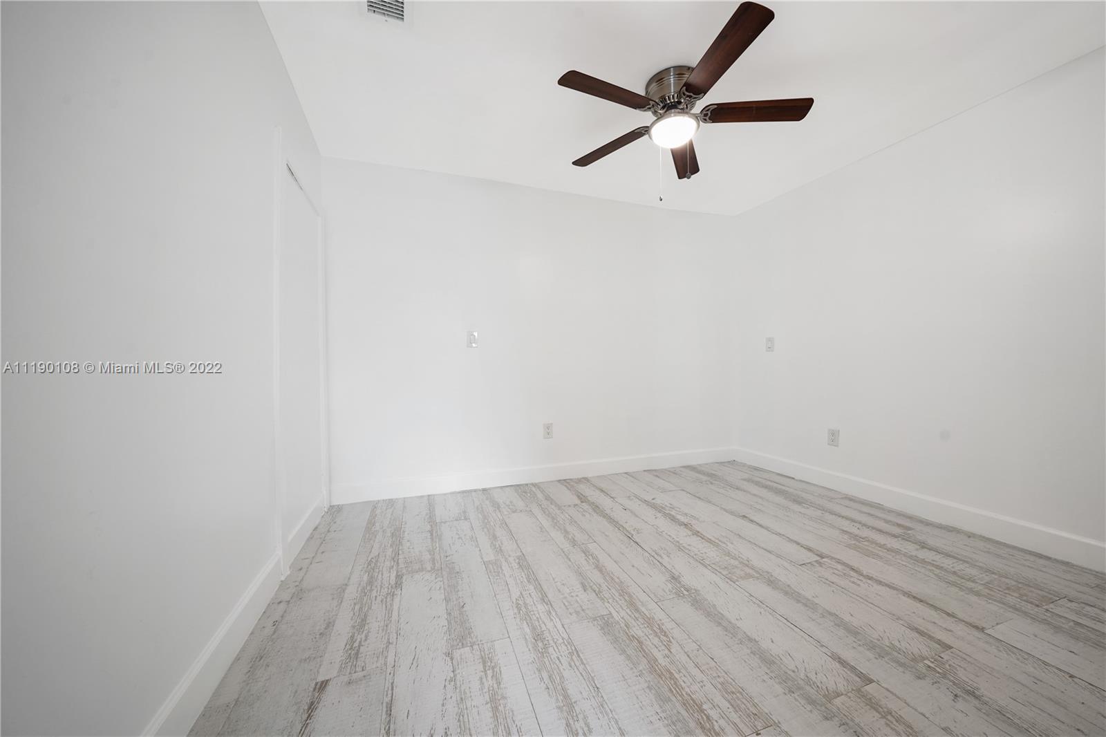 4641 Armadillo Street Boca Raton, FL 33428 - Photo 46 of 60 a view of a room with wooden floor and a ceiling fan
