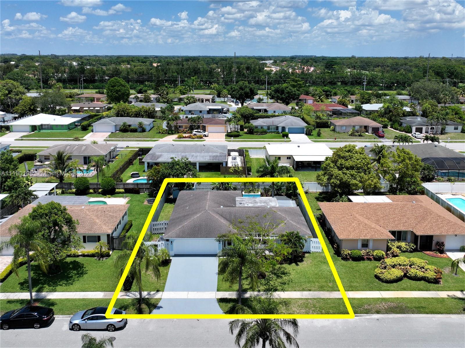 4641 Armadillo Street Boca Raton, FL 33428 - Photo 49 of 60 an aerial view of a house with a swimming pool and tennis court