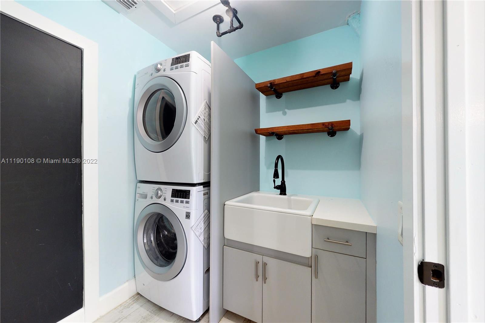 4641 Armadillo Street Boca Raton, FL 33428 - Photo 9 of 60 a utility room with dryer and washer