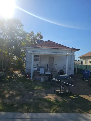 a view of a house with backyard sitting area and garden
