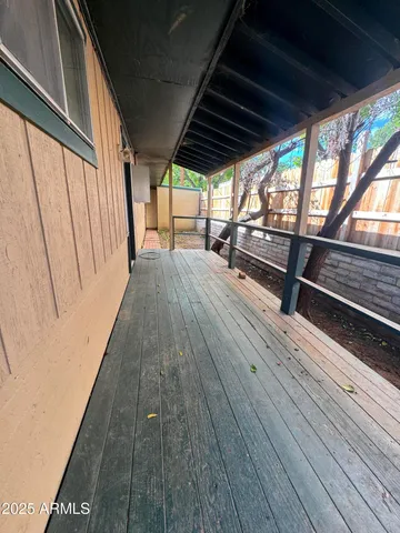 a view of outdoor space with wooden floor