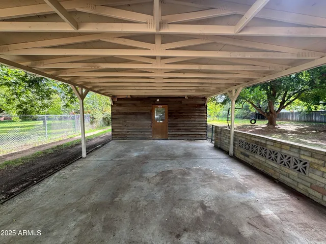 a view of a backyard with wooden fence