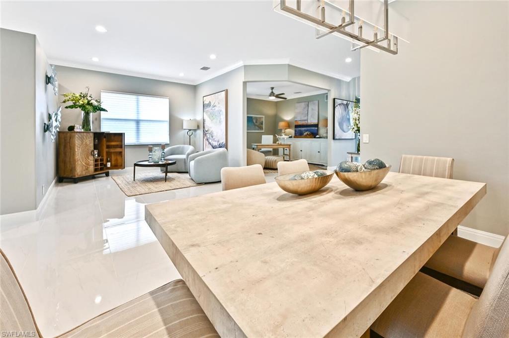 5616 Lago Villaggio Way Naples, FL 34104 - Photo 13 of 43 a large white room with chairs