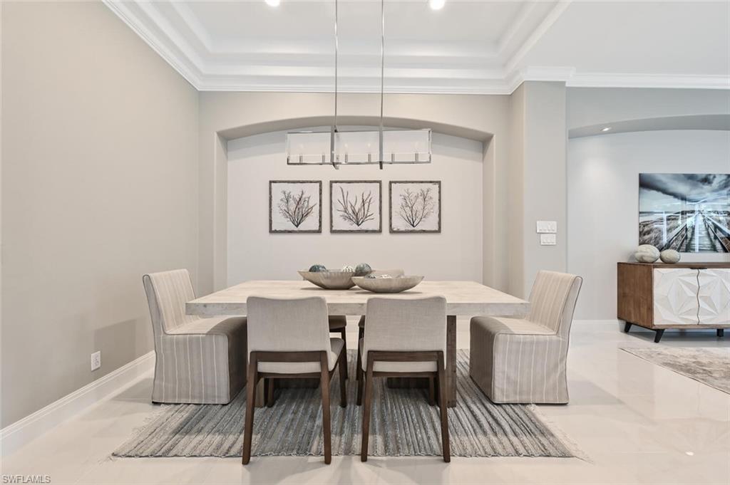 5616 Lago Villaggio Way Naples, FL 34104 - Photo 15 of 43 a view of a dining room with furniture window and outside view