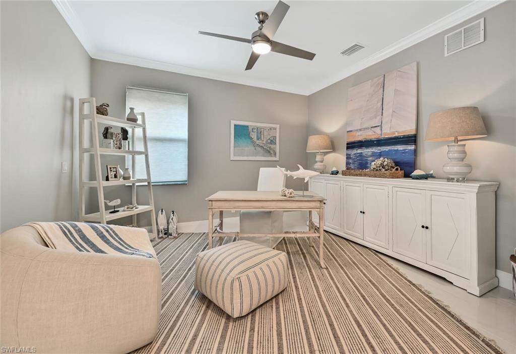 5616 Lago Villaggio Way Naples, FL 34104 - Photo 17 of 43 a bedroom with a bed and wooden floor