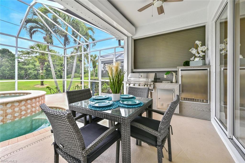 5616 Lago Villaggio Way Naples, FL 34104 - Photo 26 of 43 a dining room with furniture and a floor to ceiling window
