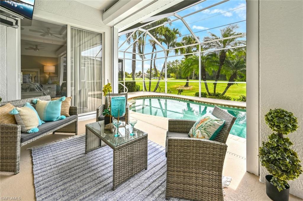 5616 Lago Villaggio Way Naples, FL 34104 - Photo 31 of 43 a living room with furniture and a large window
