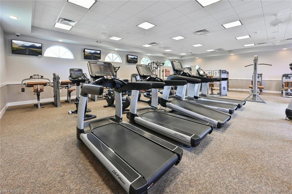 5616 Lago Villaggio Way Naples, FL 34104 - Photo 41 of 43 a gym room with lots of gym equipment