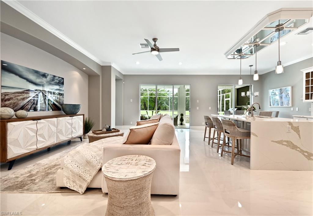 5616 Lago Villaggio Way Naples, FL 34104 - Photo 6 of 43 a living room with furniture and a large window