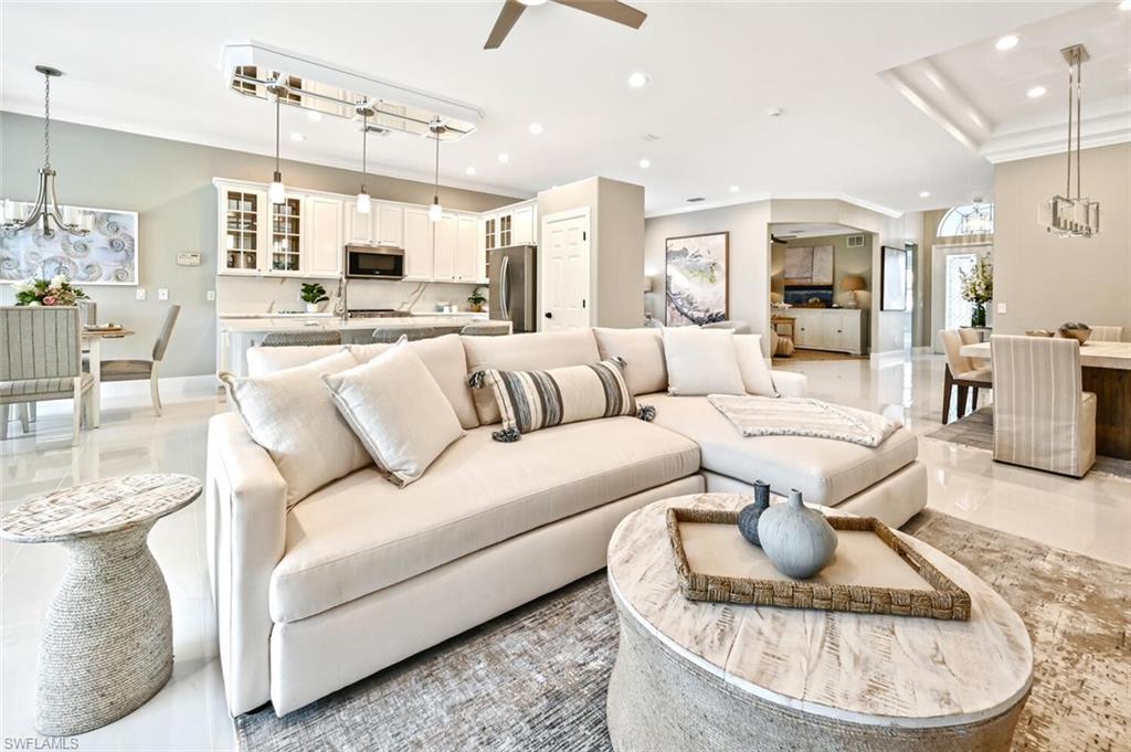 5616 Lago Villaggio Way Naples, FL 34104 - Photo 8 of 43 a living room with furniture kitchen and a chandelier