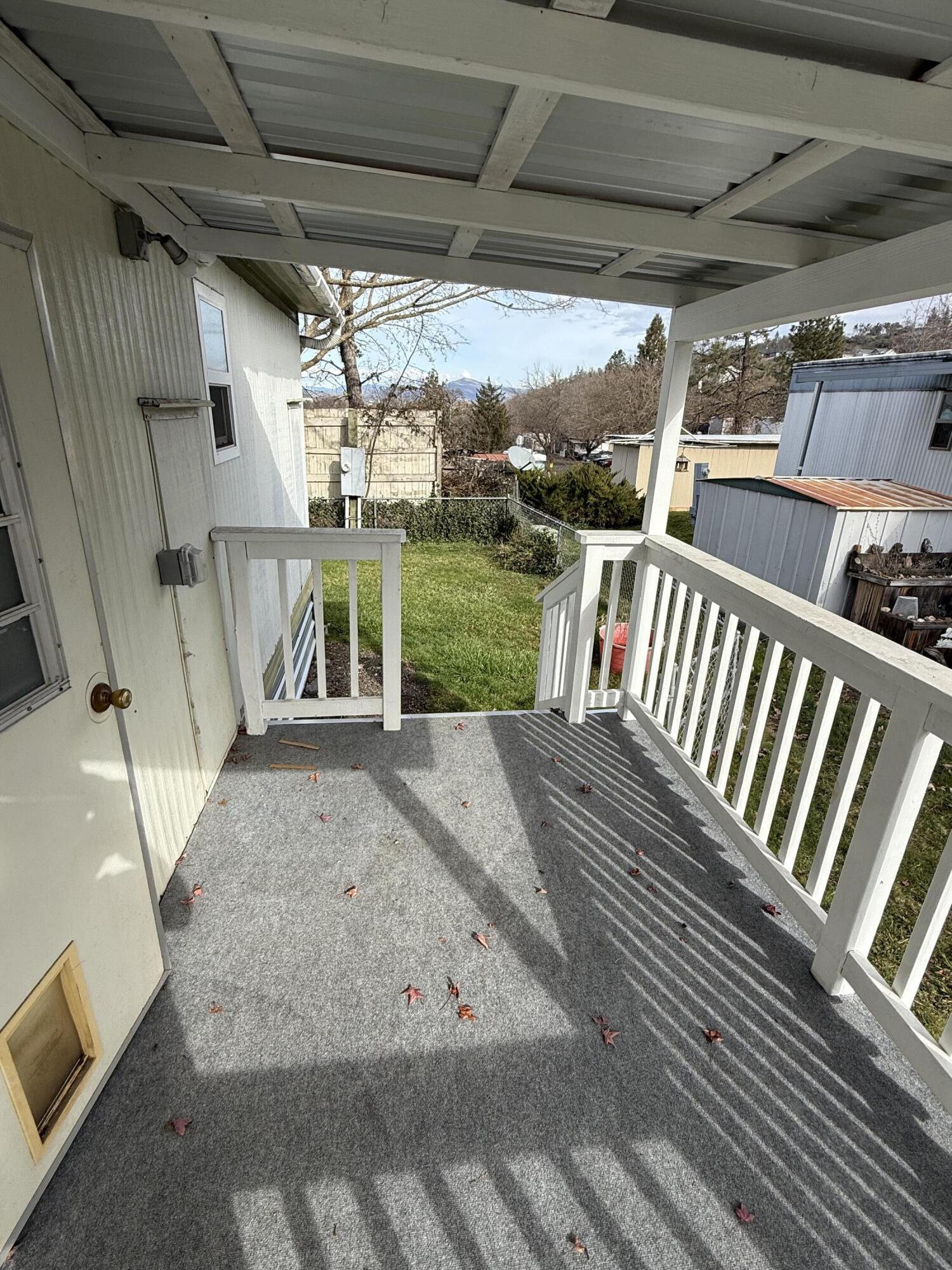 421 Stevens Road, Unit 20 Eagle Point, OR 97524 - Photo 18 of 22 a view of a porch with furniture and a yard