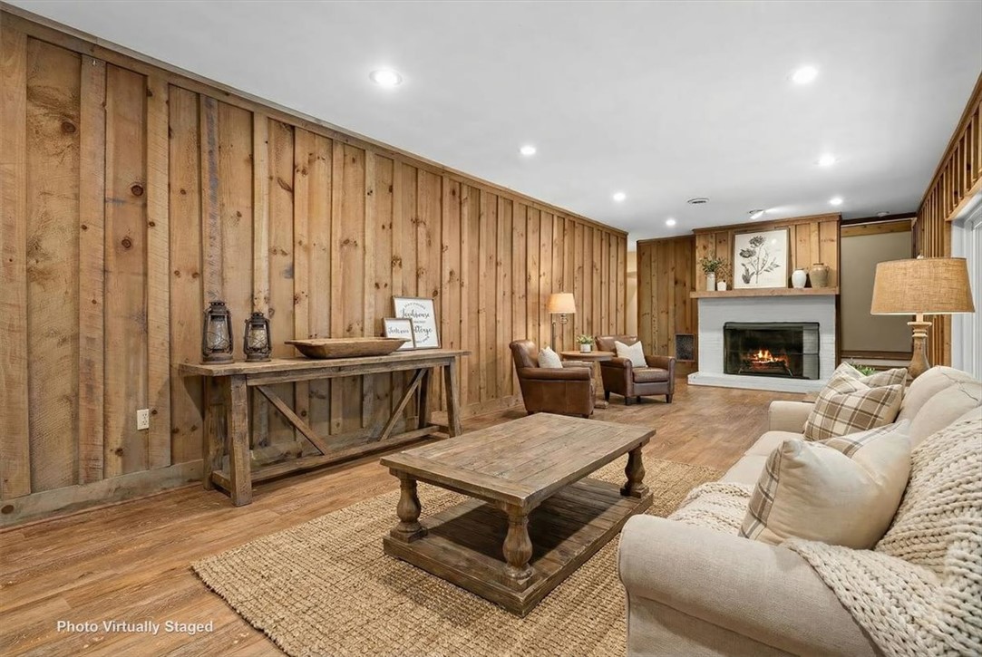 103 Satula Lane Clemson, SC 29631 - Photo 37 of 50 This living area features rich wood paneling and a cozy fireplace, creating a warm, inviting atmosphere.