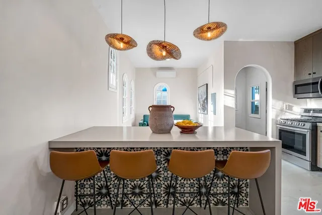 a kitchen with granite countertop a sink stainless steel appliances and cabinets