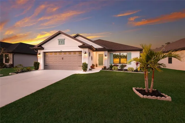 a front view of a house with a yard and garage