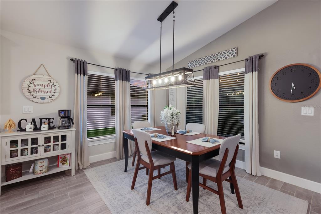 9318 46th Court East Parrish, FL 34219 - Photo 12 of 35 a view of a dining room with furniture window and wooden floor
