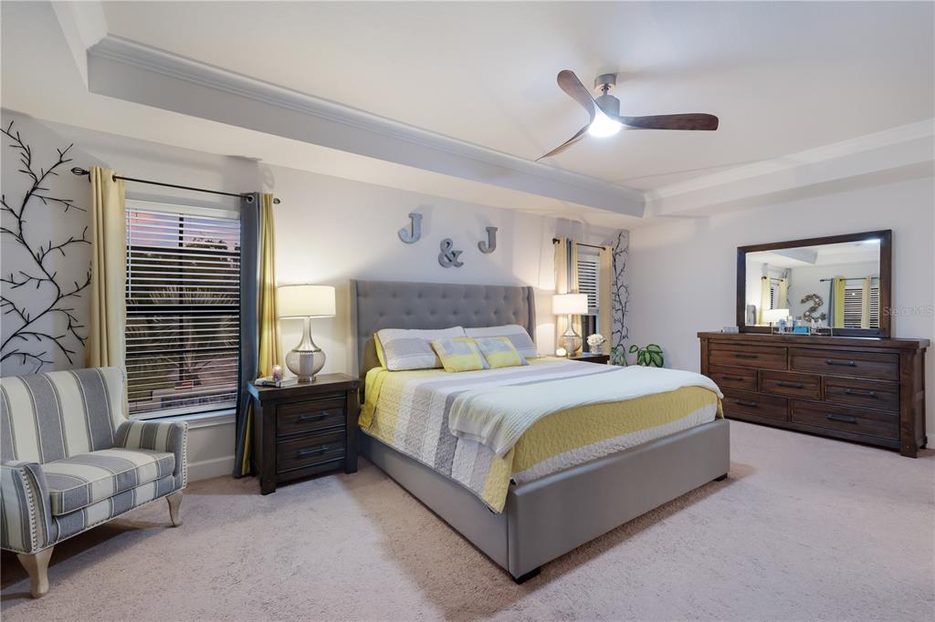 9318 46th Court East Parrish, FL 34219 - Photo 13 of 35 a bed room with a bed and a couch